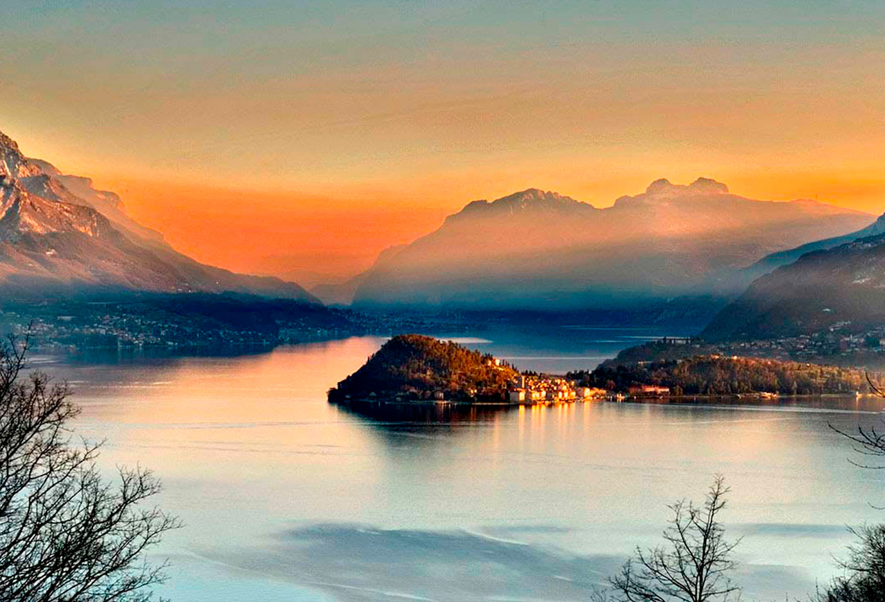 Dramatic Lake Como sunset panorama with mountains, highlighting the iconic and romantic travel destination.