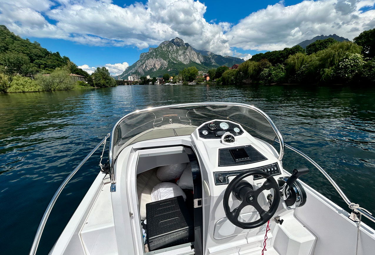 private-boat-tour-cockpit-view-lake-garlate-mountains View from the cockpit of a private boat tour on Como Lake, highlighting exclusive access to awesome scenery, to taste the Italian Lifestyle Experience