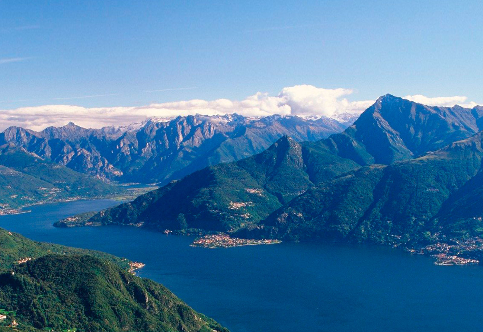 Breathtaking aerial panoramic view of the iconic Lake Como and high mountains, highlighting the luxury travel destination.
