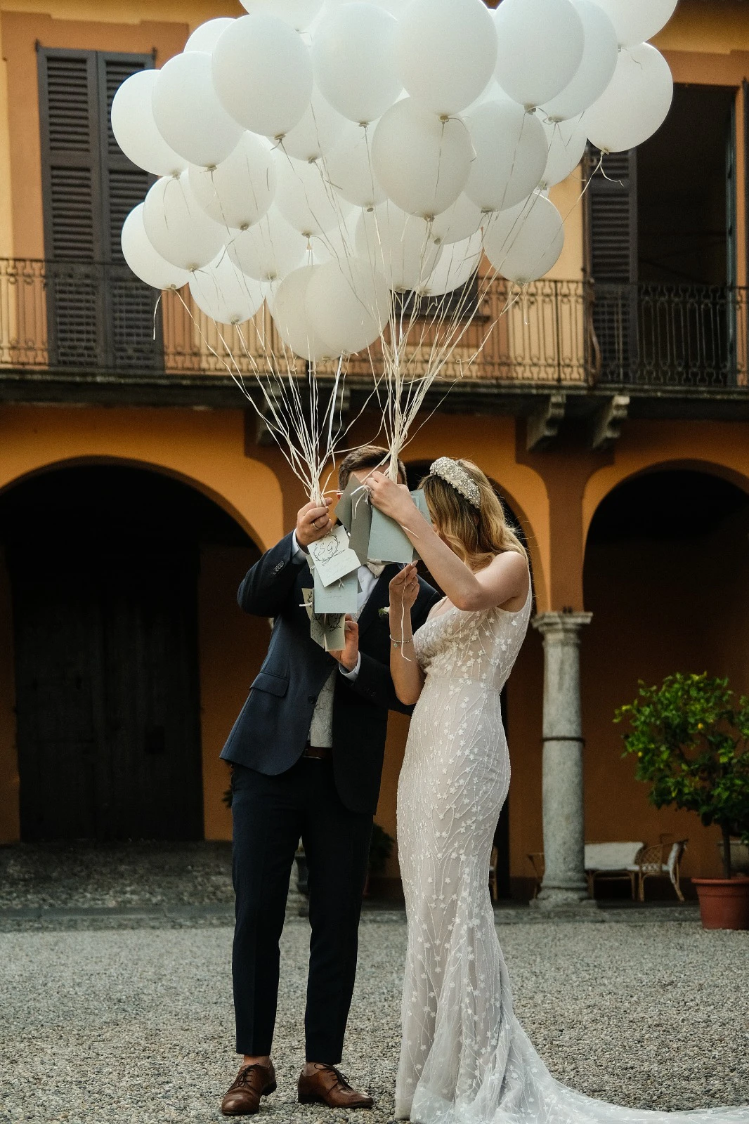 Wedding couple celebrating with white balloons at Villa Wirnica near Lake Como. Wedding couple celebrating at Villa Wirnica near Lake Como